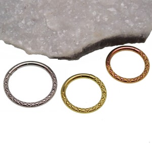 May include: Three different colored seamless rings with a diamond pattern. The rings are silver, gold, and rose gold.