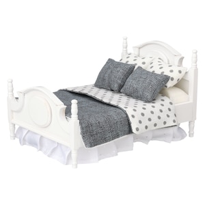 May include: A miniature white bed with a headboard and footboard. The bed is made up with a gray and white polka dot comforter, gray pillows, and a white bed skirt. The bed frame has a distressed finish.