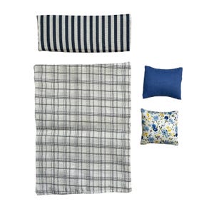 May include: A collection of miniature bedding items, including a navy and white striped bolster, a gray and white plaid blanket, a solid navy blue pillow, and a floral patterned pillow. The items are arranged on a white background.
