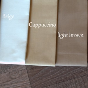 May include: Five fabric swatches in different shades of brown, from dark brown to beige. The swatches are labeled "Dark", "Beige", "Cappuccino", "light brown", and "Brown".