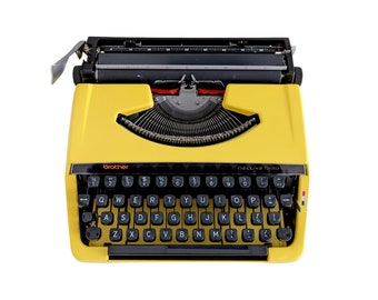 SALE!* Yellow Brother Deluxe 220 typewriter, a good working and vintage typewriter, a smaller ultraportable machine with qwerty.