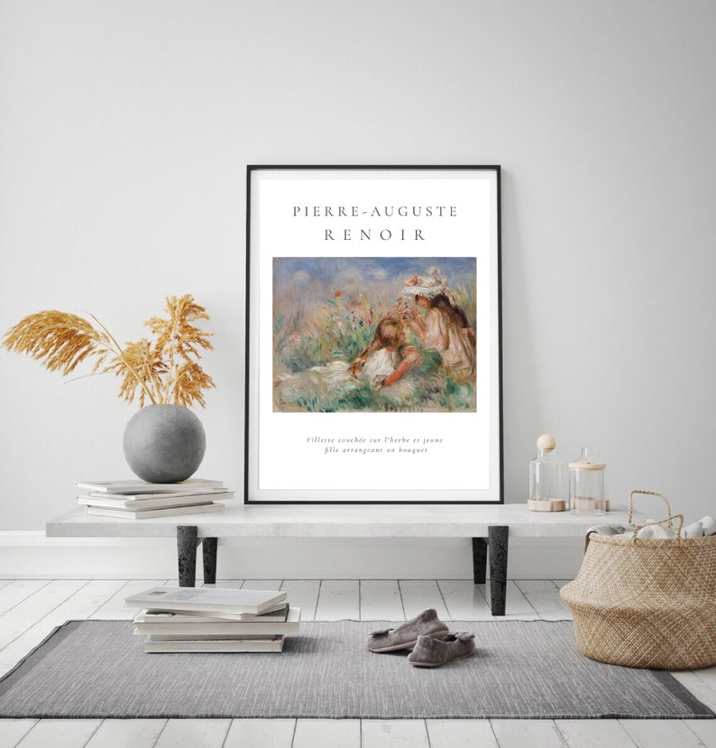 Puede incluir: Una impresi&oacute;n art&iacute;stica enmarcada que presenta una pintura de Pierre-Auguste Renoir. La obra de arte representa a dos figuras en un campo de flores. La impresi&oacute;n est&aacute; en un marco negro e incluye el nombre del artista y el t&iacute;tulo de la pintura.