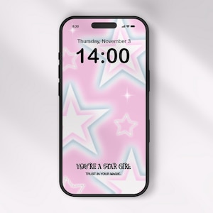 Puede incluir: Un teléfono inteligente rosa y azul con un fondo de estrellas y el texto "YOU'RE A STAR GIRL TRUST IN YOUR MAGIC." La hora es 14:00 y la fecha es jueves 3 de noviembre.