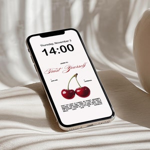 May include: A smartphone displaying a digital clock with the time 14:00 and the text "Trust Yourself" with two red cherries on a white background.