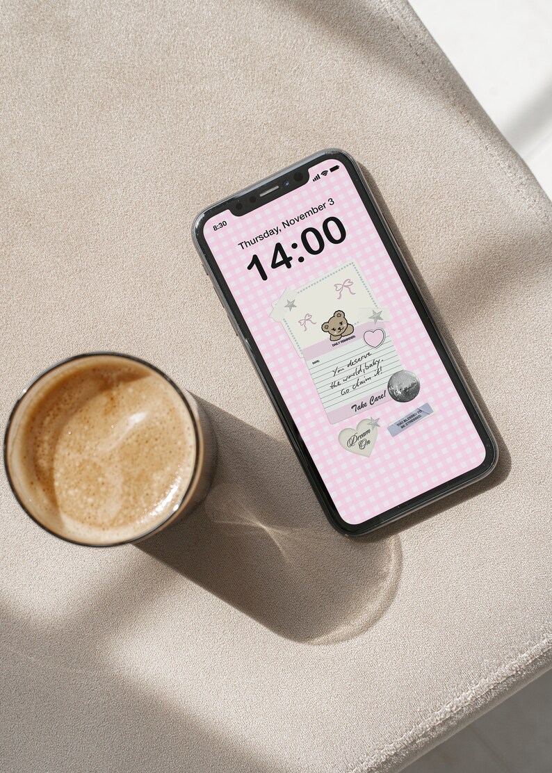 May include: A pink and white checkered phone background with a teddy bear sticker and a note that says "You deserve the world, baby. Go claim it! Take Care!" The time on the phone is 14:00.