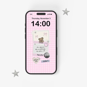 May include: A pink and white gingham phone background with a digital clock displaying 14:00. The background also features a handwritten note with a teddy bear illustration and the text "You deserve the world, baby. Go claim it! Take Care!"