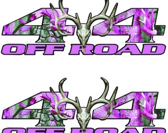 May include: Two decals featuring a deer skull with antlers centered between the numbers "44" and the words "OFF ROAD". The numbers and text are in a bright pink color, with a camouflage pattern in the numbers.
