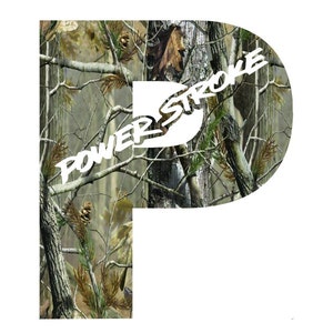 May include: A white "P" shape with a camouflage pattern of brown, green, and tan branches and leaves. The words "POWER STROKE" are in white, stylized text across the center of the letter.