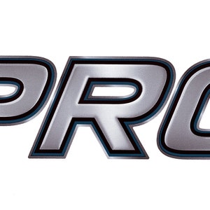 May include: A silver metallic logo with the word "PRO" in a bold, stylized font. The letters have a black outline and a blue inner shadow.