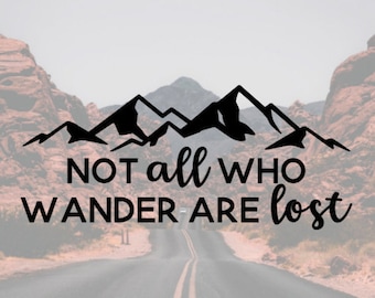 Peut inclure: Un design graphique noir et blanc d'une chaîne de montagnes avec le texte "Not all who wander are lost" en dessous. L'image est sur fond de paysage désertique avec une route qui s'étend à l'horizon.
