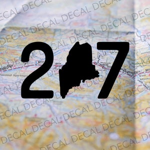 May include: Black and white silhouette of the state of Maine with the numbers 207 on either side. The image is superimposed on a map.