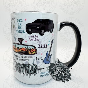 May include: White ceramic mug with a black handle and rim, featuring a black SUV graphic and text that reads "GET IN MY TAHOE." Additional graphics include a guitar, a desert scene, and the text "taking a drive to nowhere."