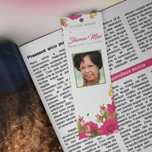 Pink Watercolor Funeral Bookmark Template for Word and Publisher is Size 2.5x7.75 inches. The funeral favor features fuchsia, green, and pink watercolor flowers combined with decorative text. Geared for memorial or funeral services.