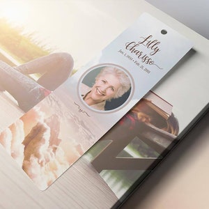 Heaven Memorial Bookmark Template for Word and Publisher is 2.5x7.75 inches. The beige, pink, and blue sunrise background with a praying hand and a dove makes this a great funeral keepsake to remember your loved one. The memory card is designed for
