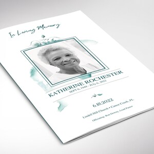 May include: A white funeral programme booklet featuring a black and white portrait of Katherine Rochester within a teal square frame. The text reads In Loving Memory, Katherine Rochester, Sept 6, 1949 - July 6, 2022, 6.18.2022, Lindell Hill Church, Canoe Creek, FL.