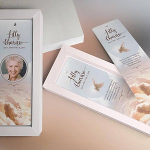 Heaven Memorial Bookmark Template for Word and Publisher is 2.5x7.75 inches. The beige, pink, and blue sunrise background with a praying hand and a dove makes this a great funeral keepsake to remember your loved one. The memory card is designed for