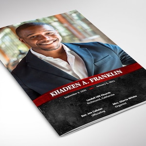 May include: A black and white funeral program with a red ribbon and the name Khadeen A. Franklin in white text. The program includes the dates September 4, 1970 and January 5, 2021, the name of the church, the officiant, and the organist.