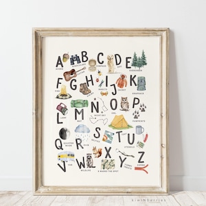 May include: A watercolor alphabet poster with illustrations of camping and outdoor activities. Each letter is paired with a word and an image, such as "A is for Acorn", "B is for Binoculars", and "C is for Compass".
