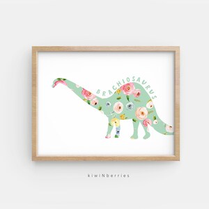 May include: A green floral print silhouette of a Brachiosaurus dinosaur. The dinosaur is outlined in white and the floral print is in shades of pink, yellow, and blue.