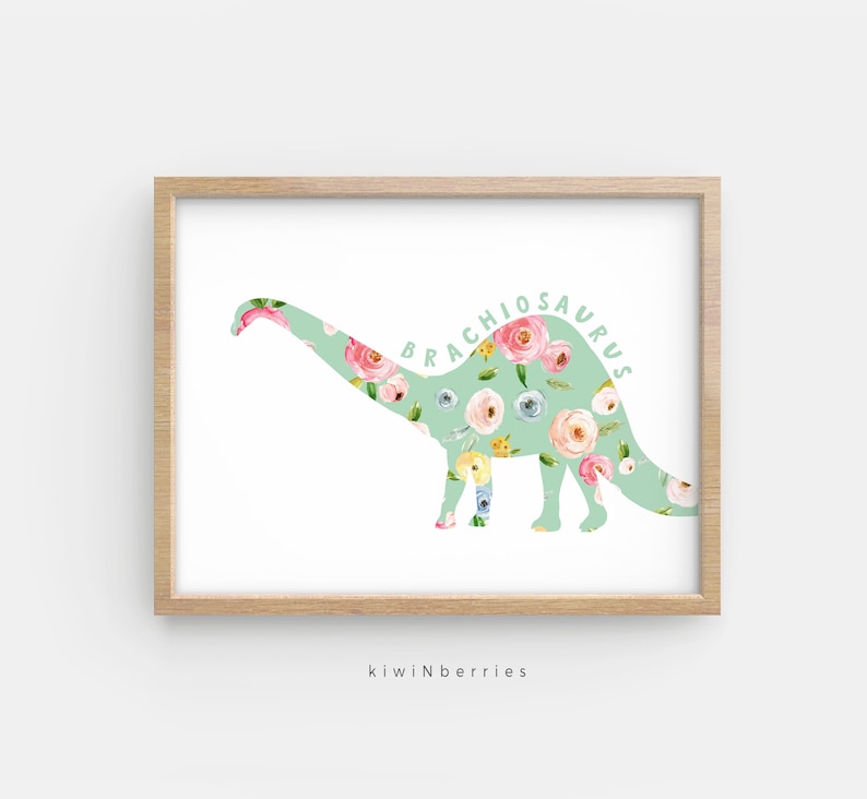 May include: A green floral print silhouette of a Brachiosaurus dinosaur. The dinosaur is outlined in white and the floral print is in shades of pink, yellow, and blue.