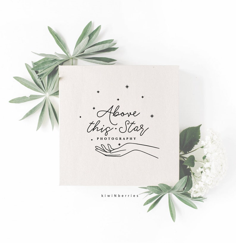 May include: A minimalist logo design with the text "Above this Star Photography" in a cursive font. The logo features a hand reaching up towards a cluster of stars.