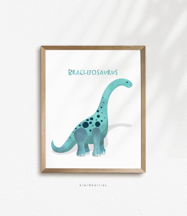 May include: A printable art print featuring a blue and green Brachiosaurus dinosaur with black spots. The dinosaur is standing on a white background with the word "Brachiosaurus" written in black at the top of the print. The print is framed in a light brown frame.