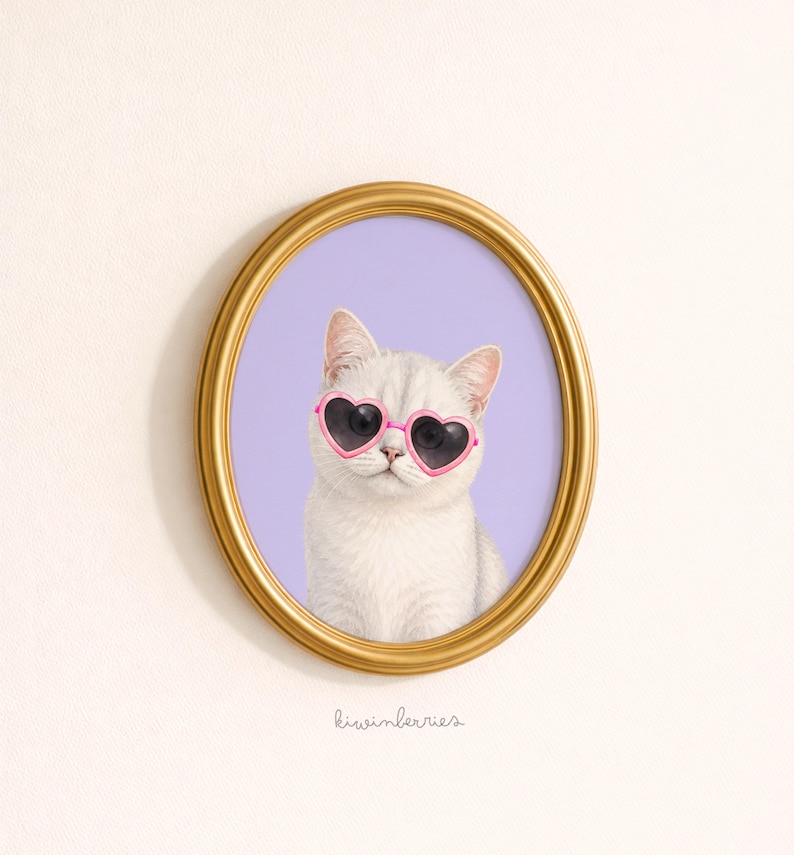 May include: A framed print featuring a white cat wearing pink heart-shaped sunglasses. The cat is set against a lavender background within a gold oval frame. The artwork has a whimsical and playful aesthetic.