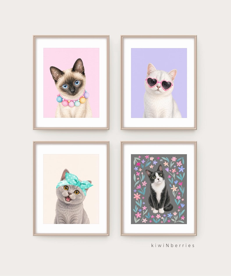 May include: Four framed cat art prints. One print features a Siamese cat with a colorful beaded collar on a pink background. Another shows a white cat wearing heart-shaped sunglasses on a purple background. The other two prints show a gray cat with a blue headband and a black and white cat surrounded by flowers.