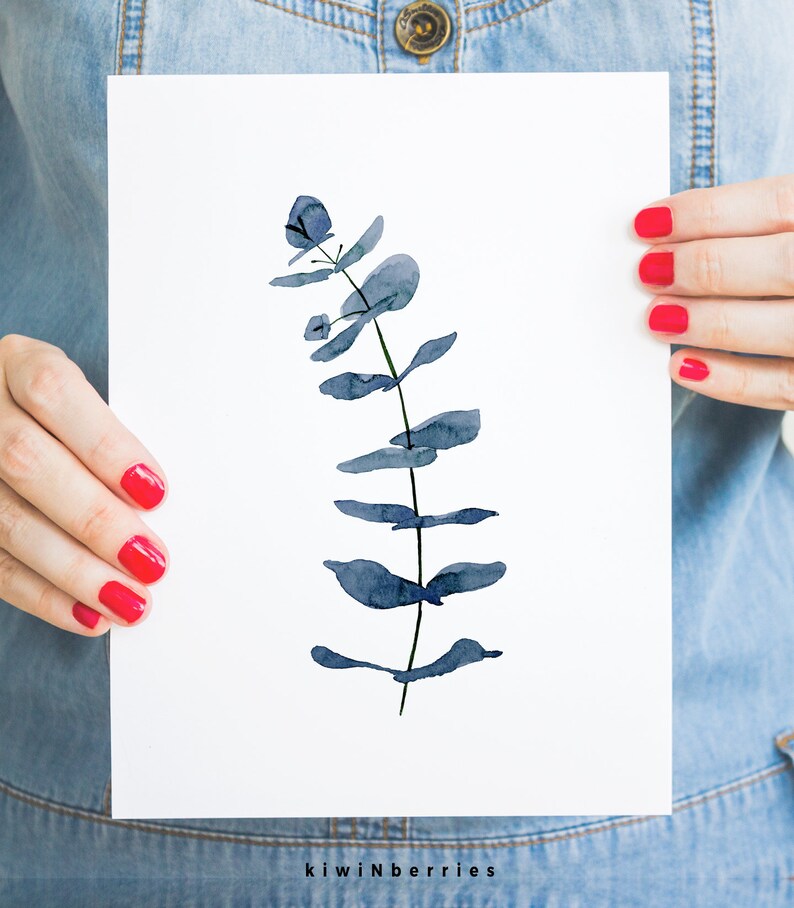 May include: A watercolour painting of a blue eucalyptus branch on a white background.