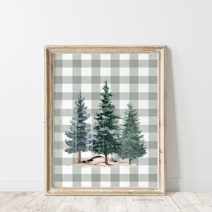 May include: A framed print of three watercolor pine trees on a gray and white gingham background.