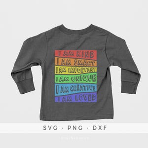 May include: A dark grey long-sleeved shirt with a rainbow-colored design on the back. The design features the text "I am kind", "I am smart", "I am important", "I am unique", "I am creative", and "I am loved".