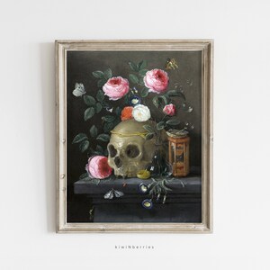 May include: A framed oil painting of a still life featuring a human skull, pink roses, a glass bottle, and an hourglass. The skull is adorned with a gold band and the roses are in various stages of bloom. The painting is set against a dark background.