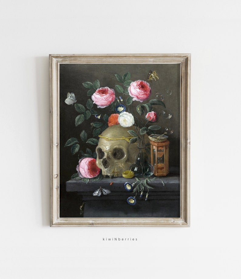 May include: A framed oil painting of a still life featuring a human skull, pink roses, a glass bottle, and an hourglass. The skull is adorned with a gold band and the roses are in various stages of bloom. The painting is set against a dark background.