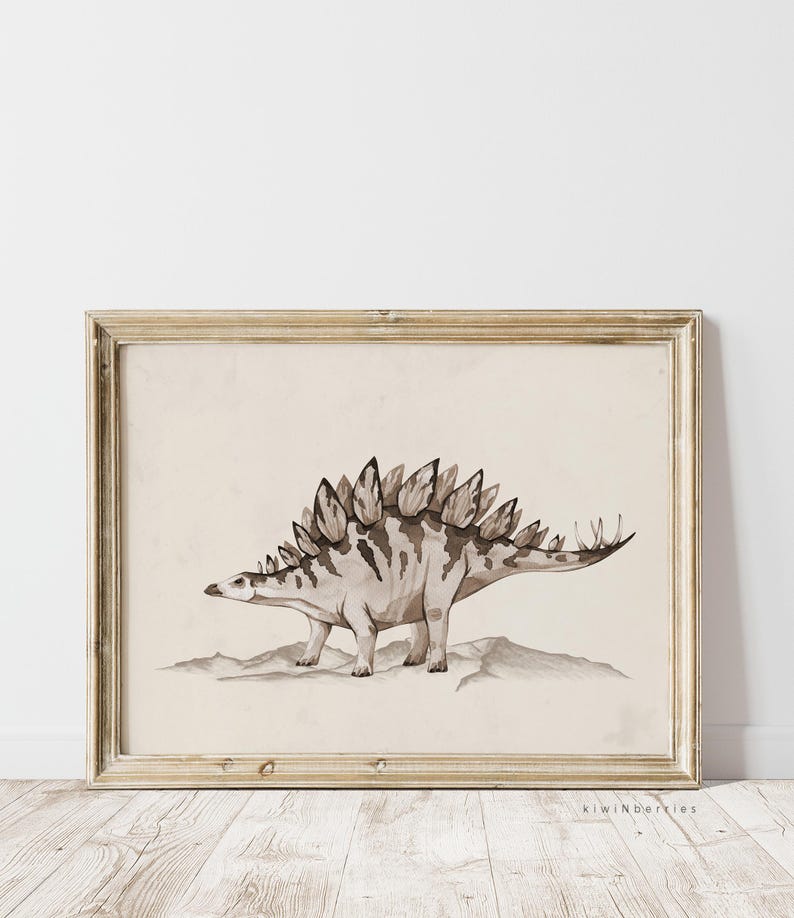 May include: A framed print of a watercolour illustration of a Stegosaurus dinosaur in shades of brown and beige. The dinosaur is depicted standing on a rocky surface.