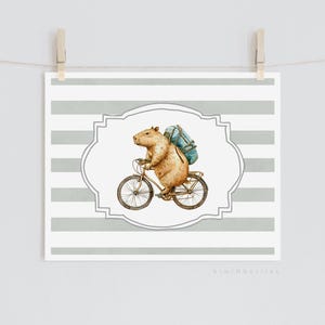 May include: A watercolour illustration of a capybara wearing a blue backpack and riding a bicycle on a grey and white striped background.