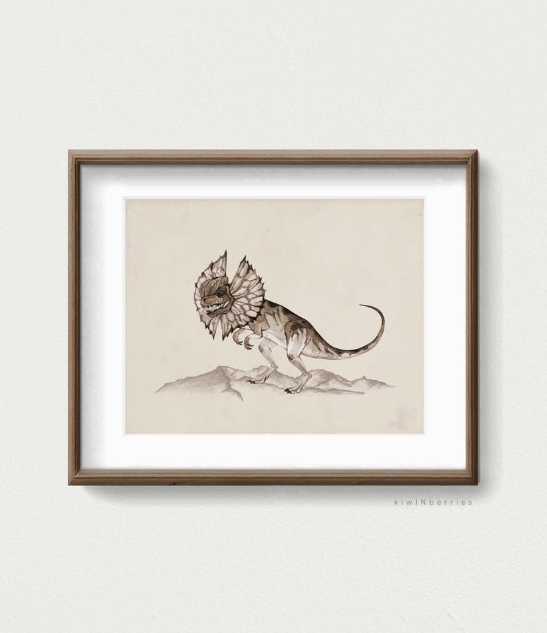 May include: A framed print of a watercolour illustration of a frilled lizard, a type of dinosaur, in a desert setting. The lizard is brown and has a frill around its neck. The background is a light brown colour.