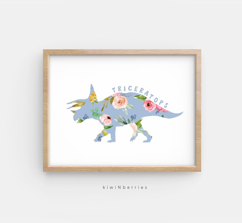 May include: A light blue silhouette of a Triceratops dinosaur with a floral pattern. The dinosaur is outlined in white and the text "TRICERATOPS" is written in blue letters above the dinosaur.