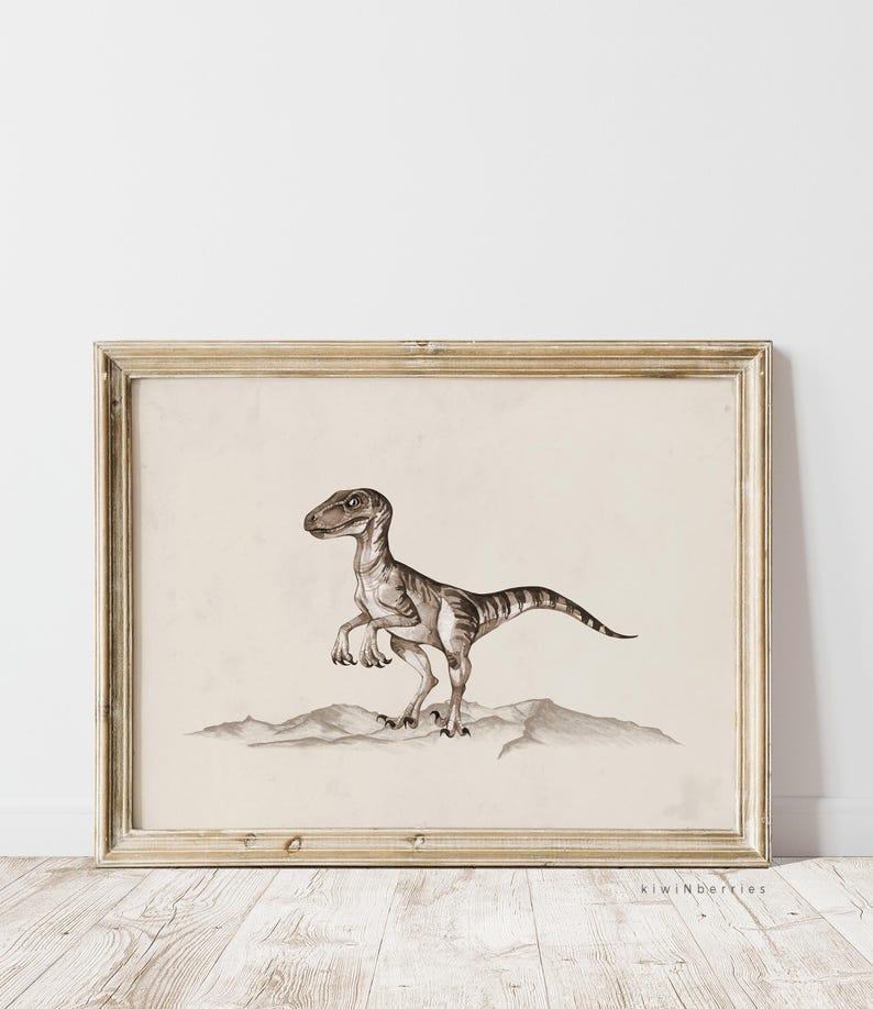 May include: A framed print of a black and white illustration of a dinosaur. The dinosaur is standing on a rocky surface. The print is in a light wood frame.