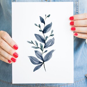 May include: A watercolour painting of a blue leafy branch with a white background.