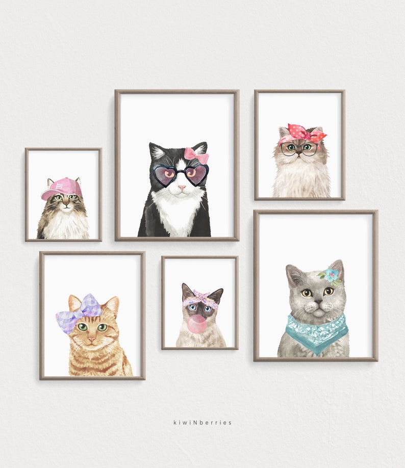 Puede incluir: Cinco ilustraciones de acuarela enmarcadas de gatos con accesorios. Los gatos son un gato blanco y negro con gafas de sol en forma de coraz&oacute;n y un lazo rosa, un gato gris con un pa&ntilde;uelo azul y una flor, un gato atigrado marr&oacute;n con un lazo morado, un gato siam&eacute;s con un pa&ntilde;uelo rosa y soplando una burbuja, y un gato de pelo largo con un pa&ntilde;uelo rosa y gafas.