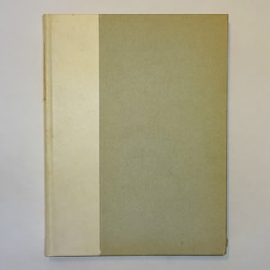 May include: A hardback book with a white spine and a green cover.