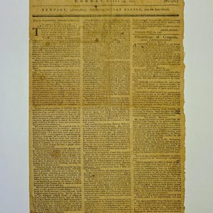 May include: Aged newspaper page titled "The Newport Mercury," dated April 13, 1797. The paper has a yellowed, aged appearance with visible wear and tear. The text is in black ink, with columns of small print. The top banner reads "Proceedings of Congress."