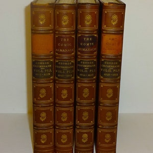 May include: Four brown leather-bound books with gold lettering and illustrations. The books are titled "The Comic Almanack" and feature the name "George Cruikshank" and the volume and year of publication.