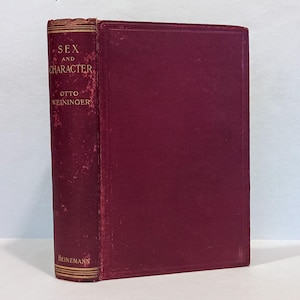 May include: A vintage hardcover book titled "Sex and Character" by Otto Weininger. The book has a burgundy cover and spine with gold lettering. The publisher's name, Heinemann, is printed at the bottom of the spine.