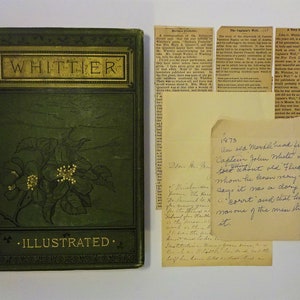 May include: A green book with gold lettering that reads "WHITTIER ILLUSTRATED." The book is surrounded by several pieces of paper with handwritten text, including a note that reads "1873 Au sed Mastle head fisherma Death Captain Jolen White in the toed don't old Flus Ourson whom he tenen very well, dory not a says it nas a court and that his father nas one of the men en steal dragged it."