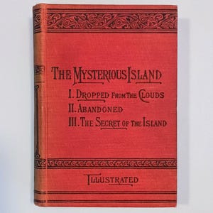 May include: A vintage book titled "The Mysterious Island" with a red cover and black text. The cover features decorative borders and the text "Illustrated" at the bottom. The book's chapters are listed below the title.
