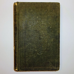 May include: A vintage green book with a decorative design on the cover. The book is bound in a dark green cloth with a gold border.