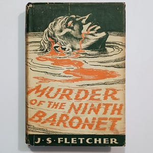 May include: A vintage hardcover book titled Murder of the Ninth Baronet by J.S. Fletcher. The cover features a dark green background with a graphic illustration of a head submerged in liquid, with bright orange fluid flowing from the mouth.