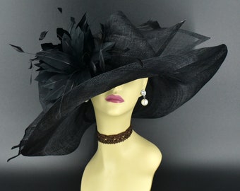 May include: A large black hat with a wide brim and a black feather accent. The hat is made of a sheer material and has a delicate, feminine look.