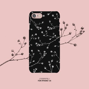 May include: Black phone case with a white floral pattern. The case is designed for iPhone 7/8 and has the text "L'ESSENTIEL I" printed on the bottom.